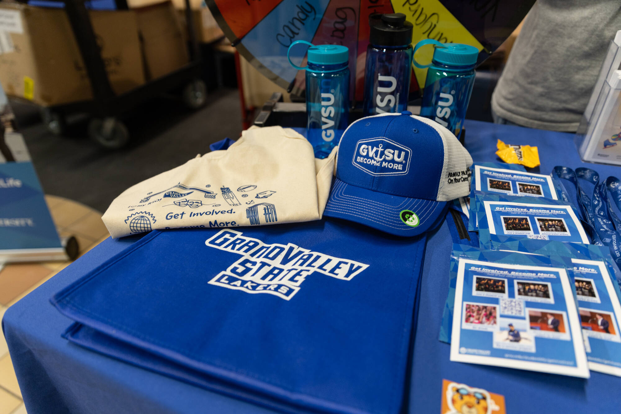 A GVSU tote bag, water bottle, and hat on a table